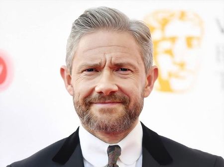 Martin Freeman smiles while posing for a picture